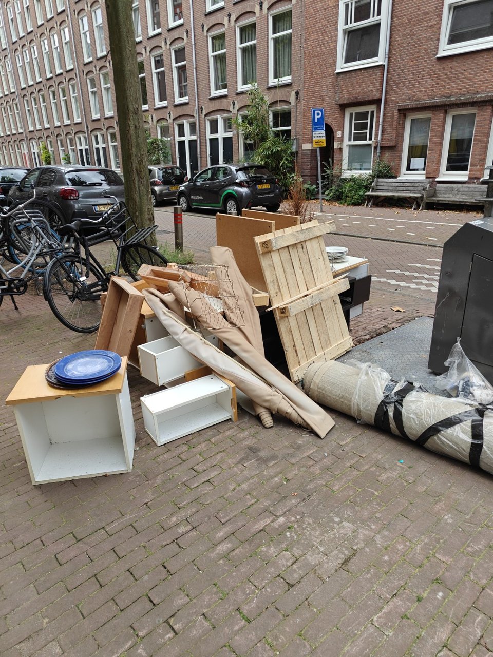 Disassembled cabinets and table, big rug