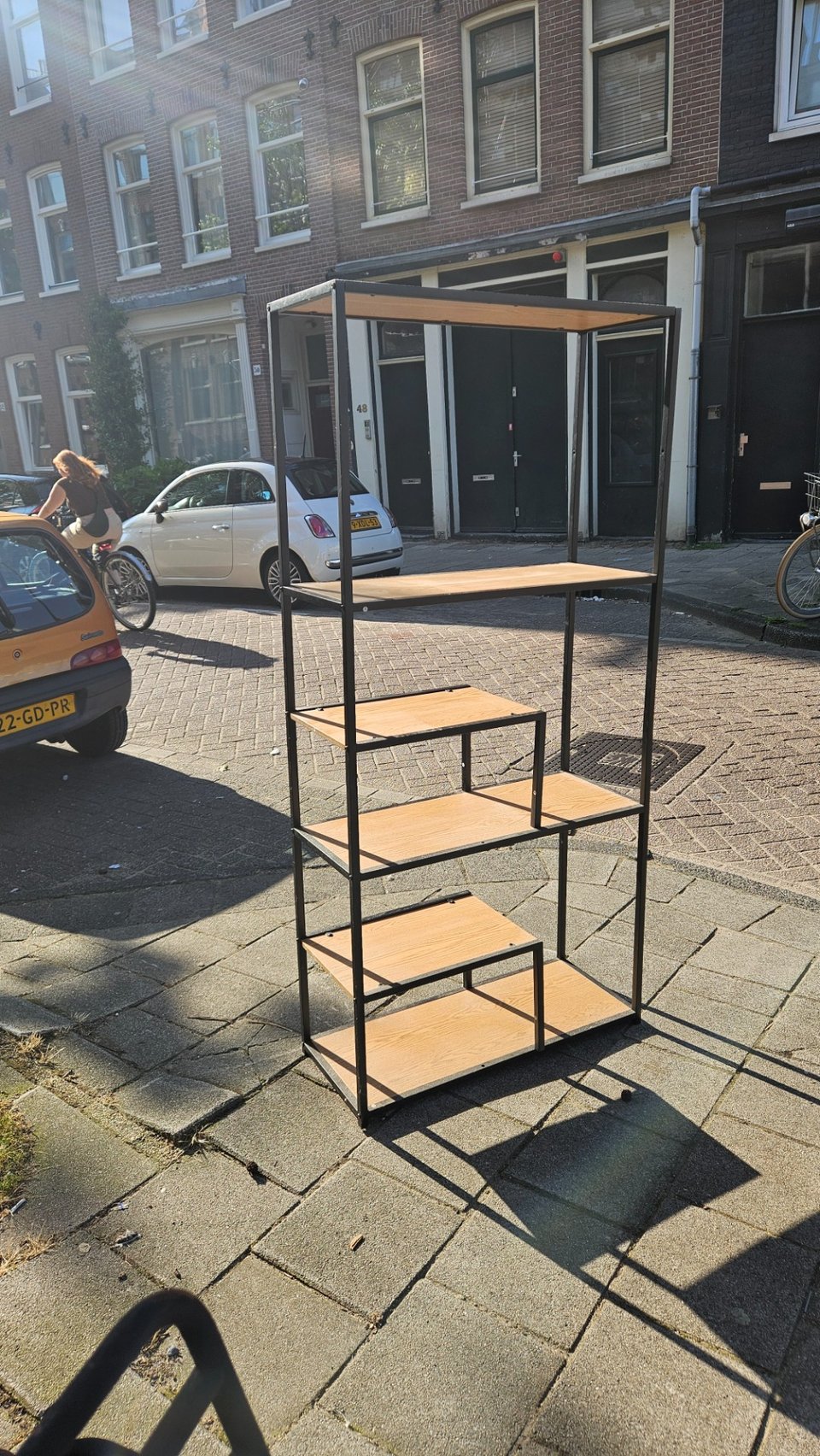 Metal and wood shelving unit. It looks in good condition.