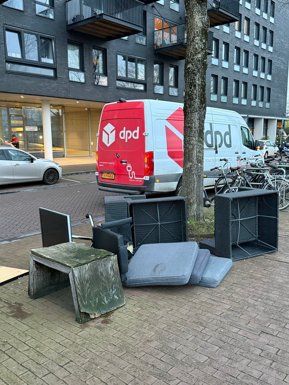 Grey balcony furniture ( and pillows) , monitor, office chair