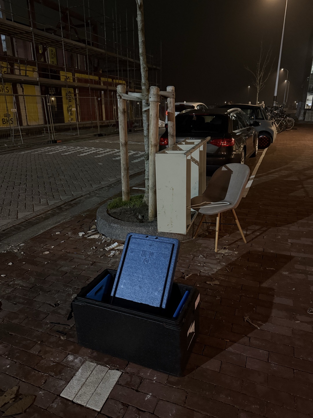 Clean Insulated cooler box (for food) including ice packs a chair, and open shelving unit.