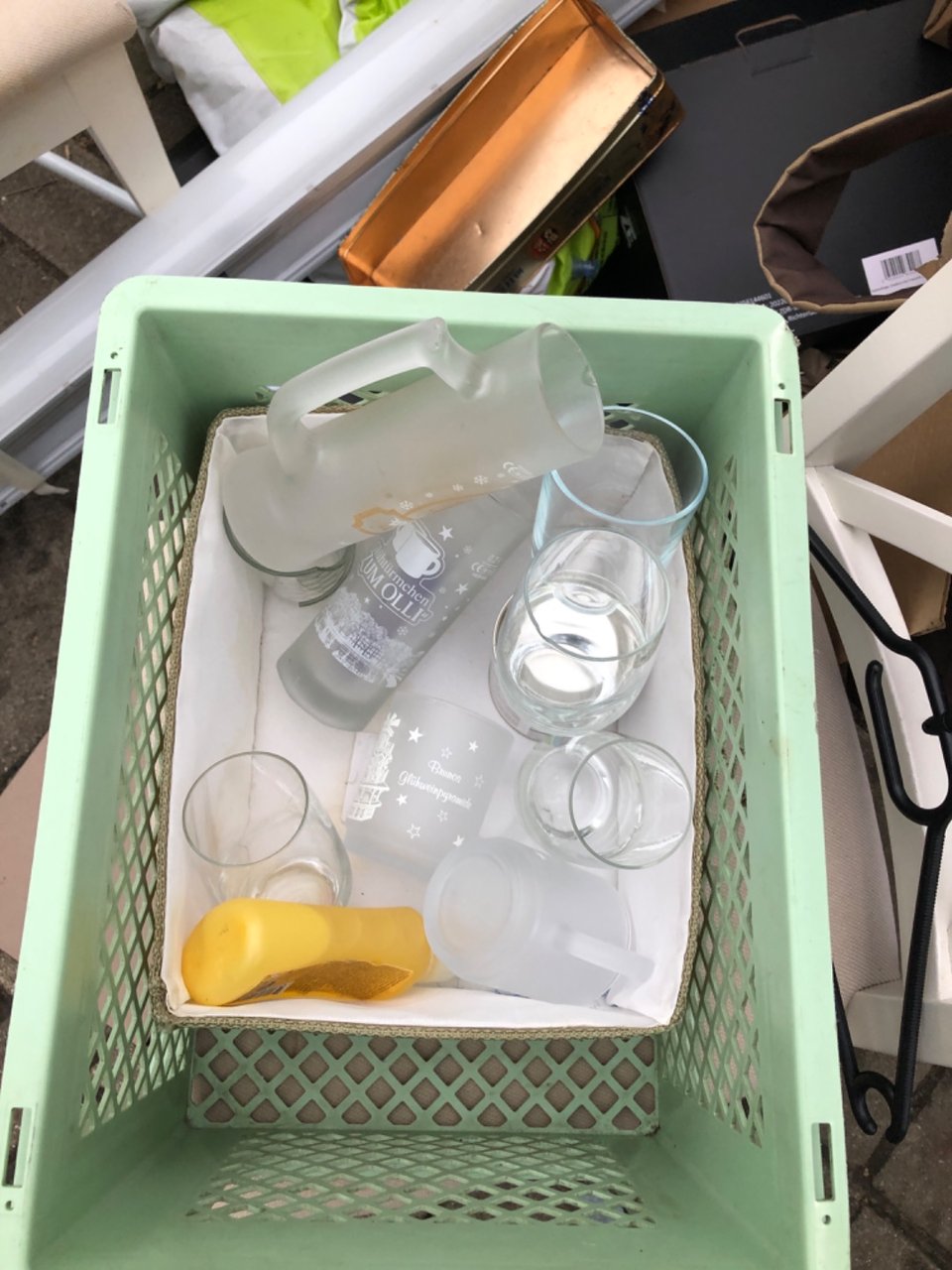 Glasses two chairs a plate, a black seat under the matras and a reed blind