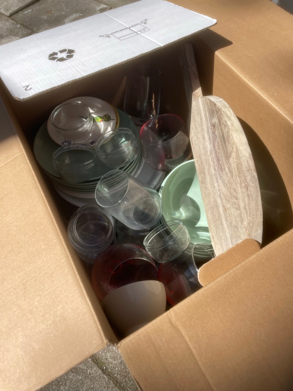 Box full of plates, bowls, glasses and more